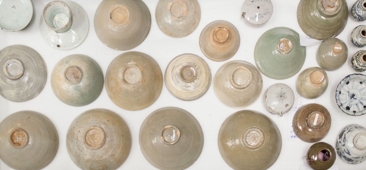 Open drawer in the collections storage for Mingei International Museum containing Korean ceramics.