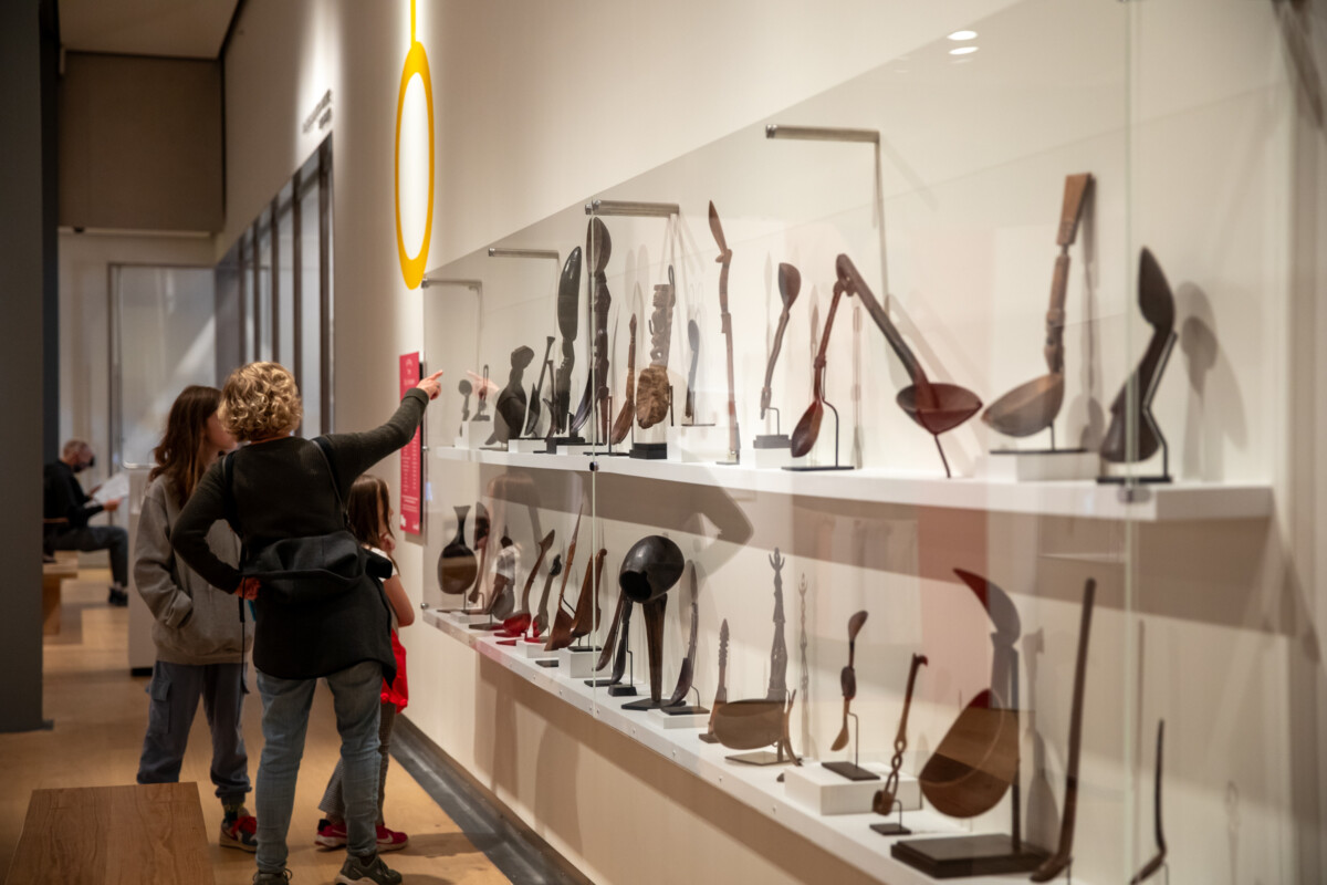 People looking at a display of spoons