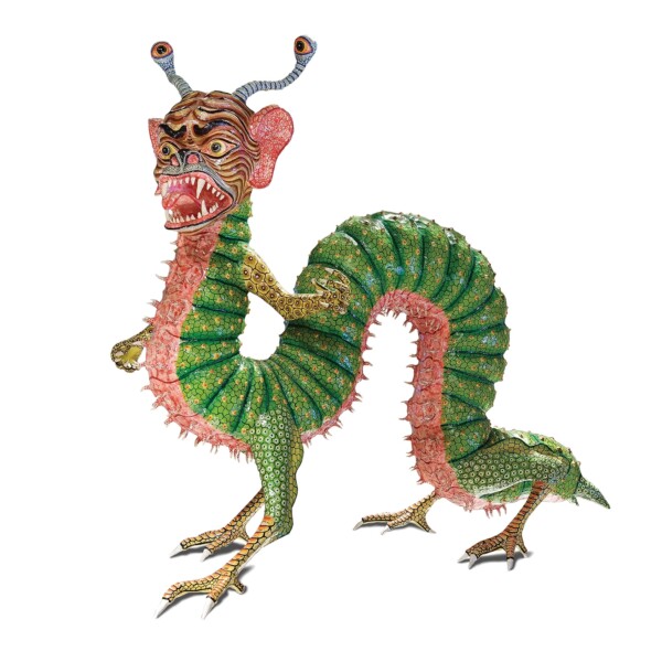 An Alebrije is a brightly colored Mexican Folk Art sculpture typically depicting a mythical creature. This Alebrije has the body of a caterpillar, 4 webbed feet and a creature-like face. It’s green with yellow spots and its underbelly is pink with red veins spidering out. It's has large, human-like ears, an antennae on top of its head. Its face has large expressive eyes, with stripes on its face and its mouth is open exposing its sharp teeth.