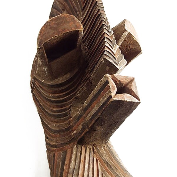 This wooden mask's face is boldly simplified with a high protruding forehead, close-set eyes under hooded eyelids, and is completely covered by a dense network of painted parallel grooves.