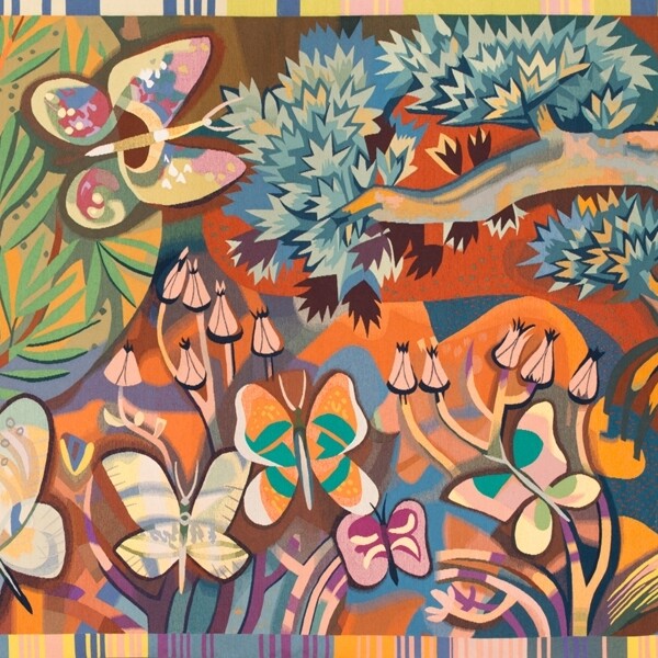 This wool tapestry was made using traditional French tapestry techniques. It is brightly colored and features butterflies, trees, and plants. In the left corner there is a person sitting down enjoying the natural landscape.
