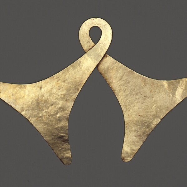 This is a gold body ornament. It is one piece of gold formed into two bell shapes.