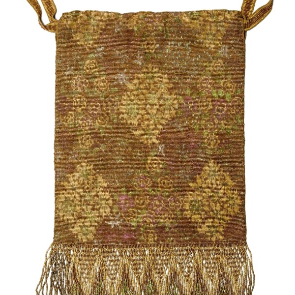 This purse is rectangular with fringe on the bottom.  Its color is yellow and brown, and it has a faint damask pattern..