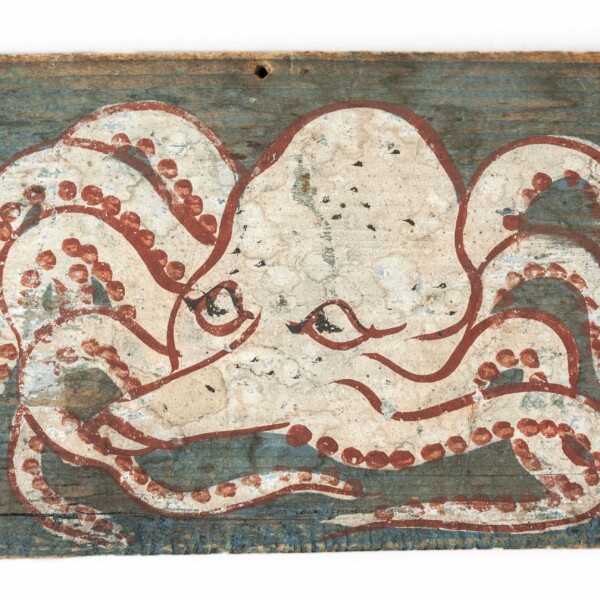 Painted on this ema, a small wooden plaque, is a white octopus with red highlights. The background of is painted light blue.
